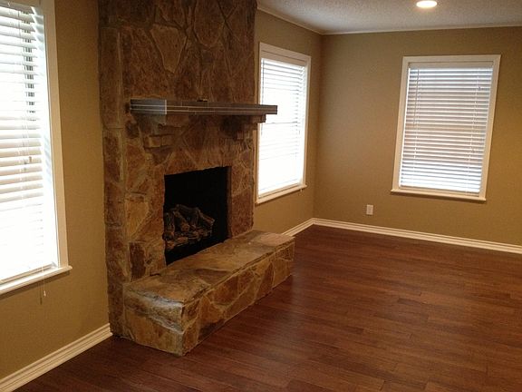 living room w custom stone fireplace