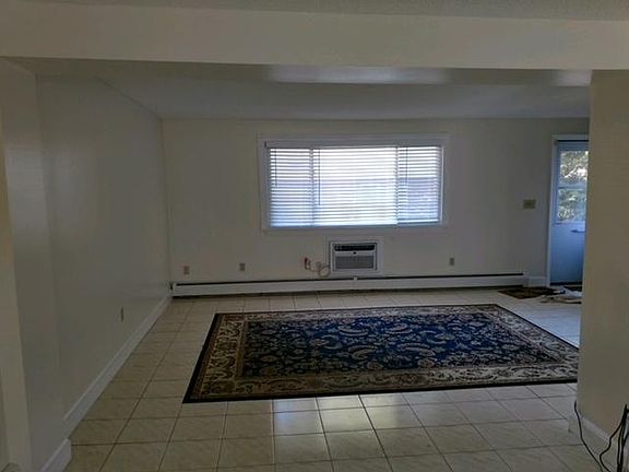 Living Room, very spacious and flows into the dining room. Built in wall A/C.