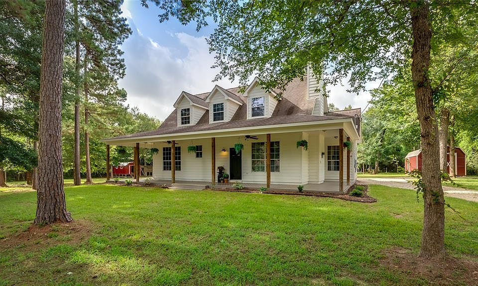 Gorgeous home features front wrap around porch, complete with ceiling fans, with trees to shade early mornings or late evenings.