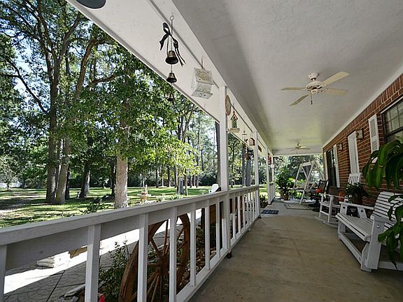 WRAP AROUND COVERED FRONT PATIO.