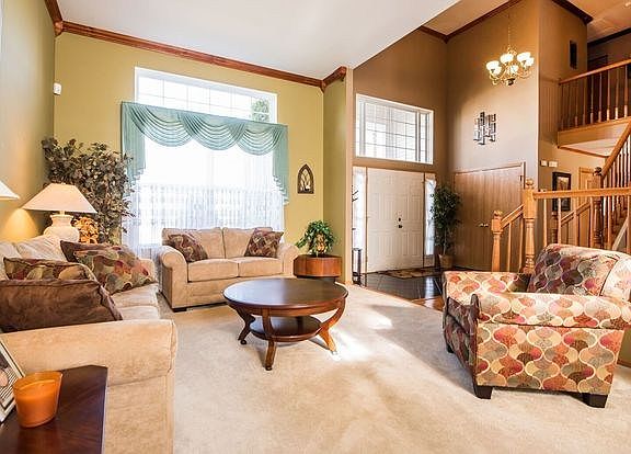 Spacious living room which is open to the dining room.  Custom crown moulding and a larger than life window makes this room brig