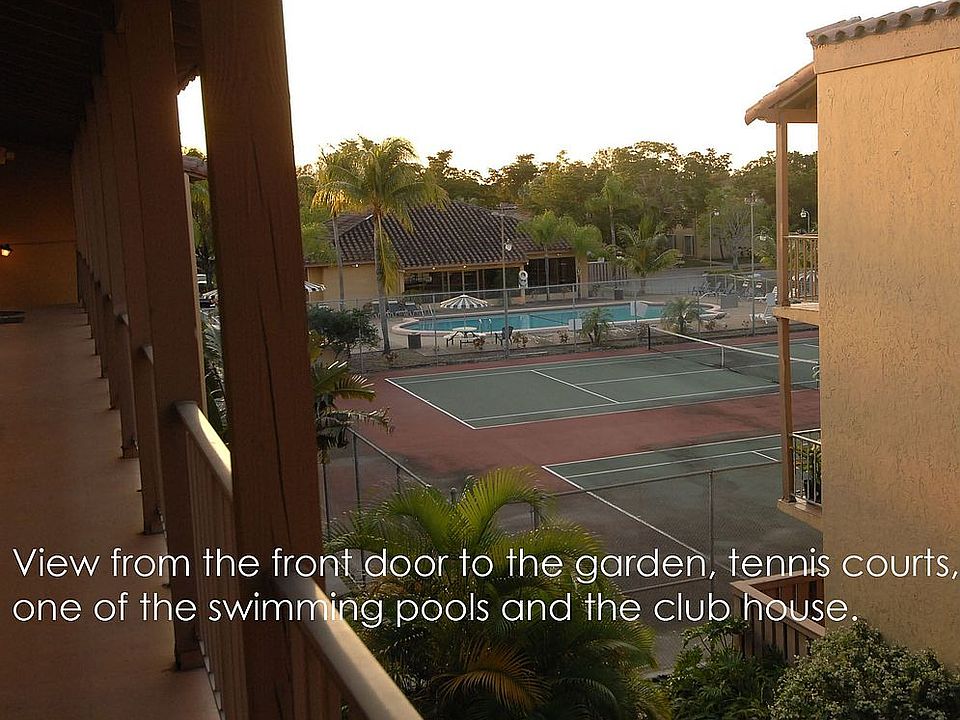 view of tennis, pool and clubhouse from front door