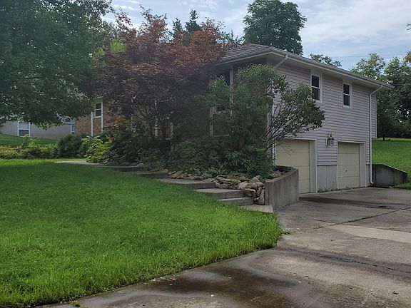 2 car garage and large yard with a long driveway.