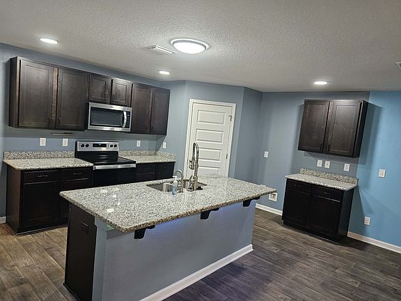 Kitchen (angle 1)

Kitchen with granite countertops, island seating, and dual faucets for the sink.