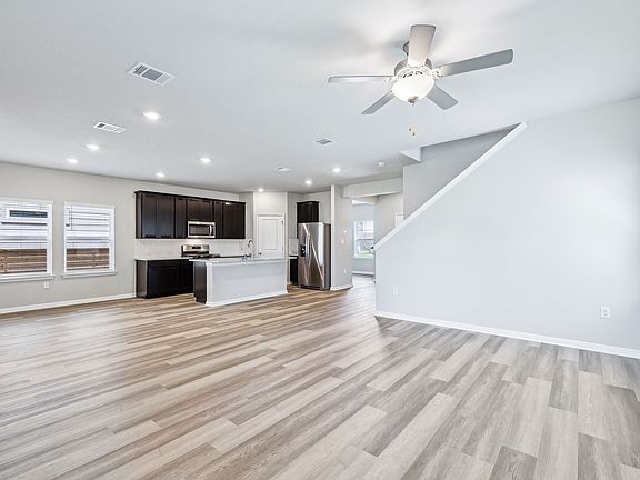 The open concept kitchen, living, and dining areas are great for hosting company.