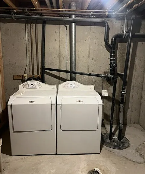 LAUNDRY ROOM WITH WASHER AND DRYER AND EXTRA STORAGE.