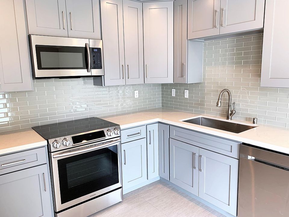 Sparkling glass tile backsplash accents the Chef's range and beautiful cabinetry