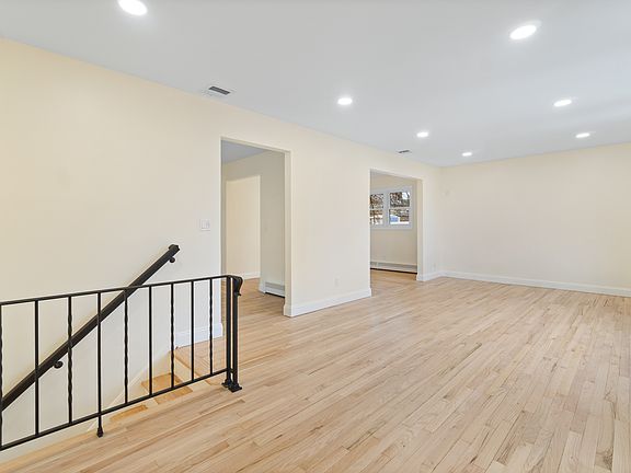 Living room with view of kitchen and dining room entrance