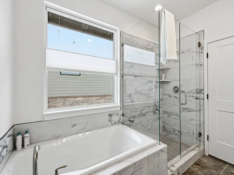 Master bathroom with large tub and walk in shower