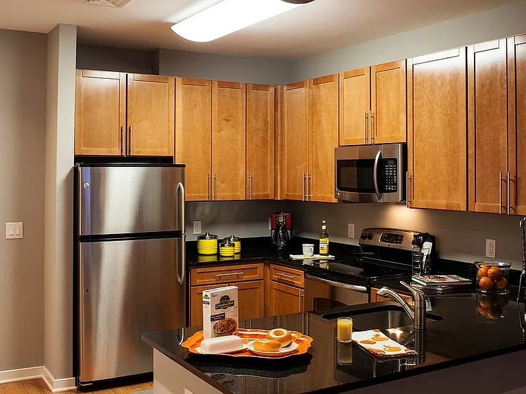 Contemporary Kitchen With Granite Countertops, Wood Cabinets & Stainless Steel Appliances