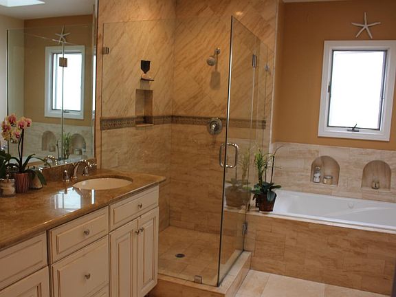 Master bathroom with travertine floors, marble counters, Jac