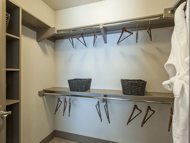 Organized closet space with ample shelving.