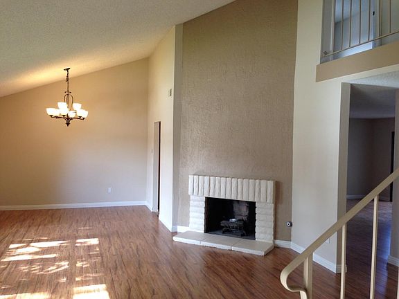 Open Living Room & Dining Room with Cozy Fireplace