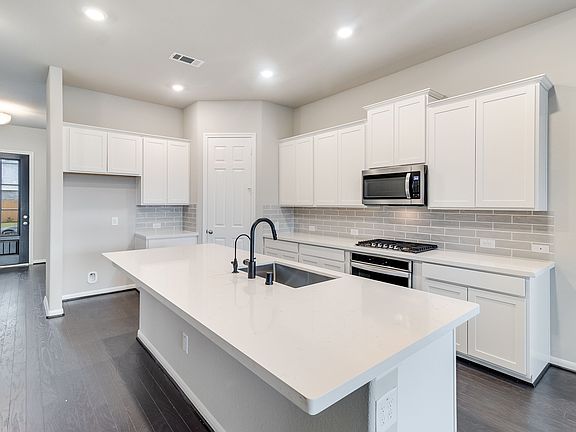 Welcoming kitchen with plenty of countertop space and cabinetry