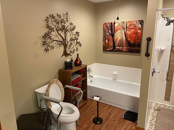 Bath showing handicap accessible shower with separate tub.