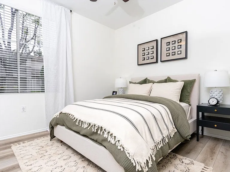 Cozy Bedroom Featuring Modern Bedding and Framed Wall Art