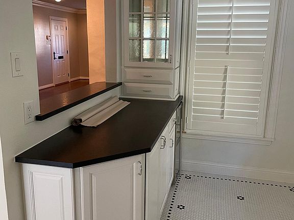 Wet bar, adjacent to kitchen with window to dining room