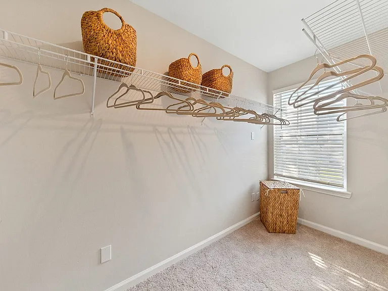 Expansive Walk-In Closet with Window at Theater Street Apartments