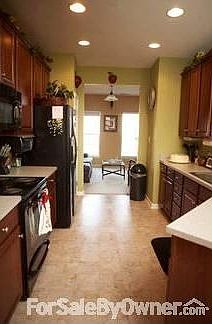 Kitchen : Open w/ plenty of counter space;offering a full view of den/study/sunroom area.