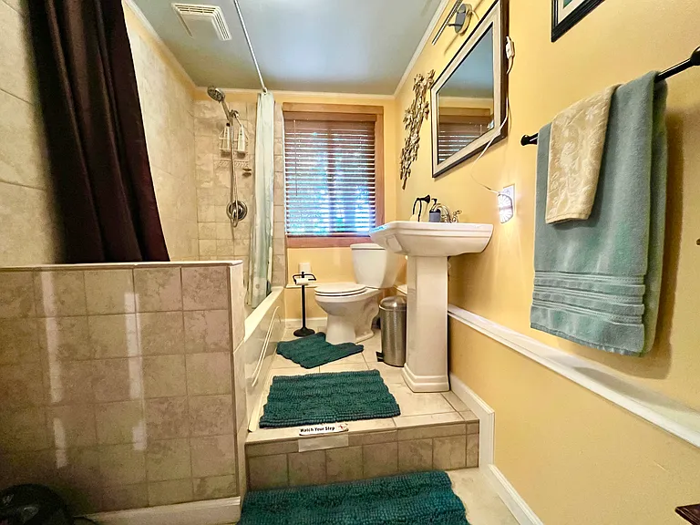 Beautifully tiled bathroom with very large bathtub