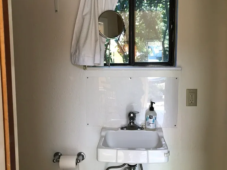 Bathroom looks out on creek