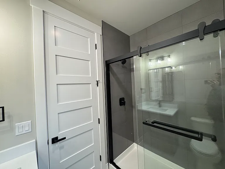 Tile surround shower with sliding glass doors