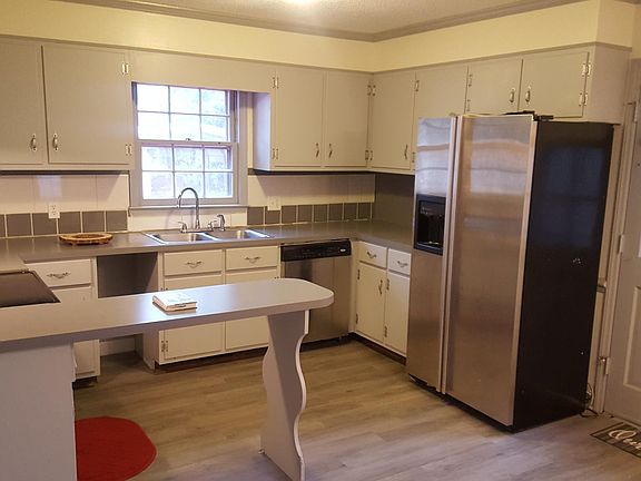 Beautiful modern kitchen with stainless steel appliances and backsplash.