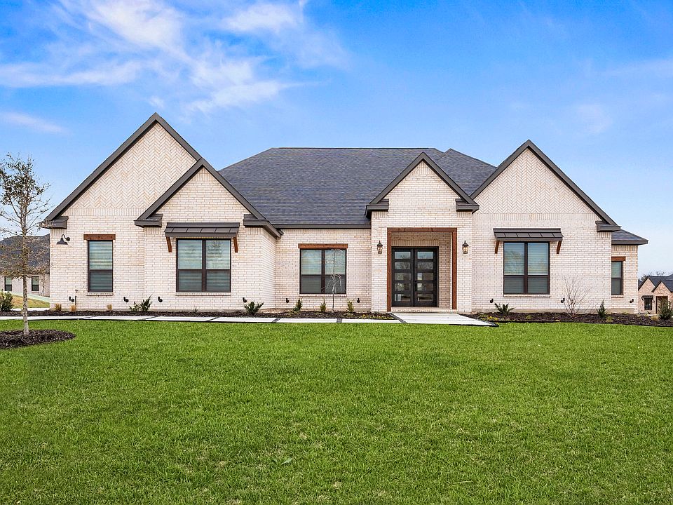 The Mantle II is a beautiful, one-story brick home with wood accents.
