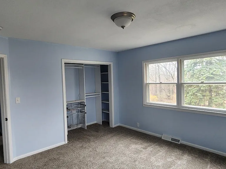 this is the third bedroom upstairs. tons of light and brand new carpet with an 8x8 closet