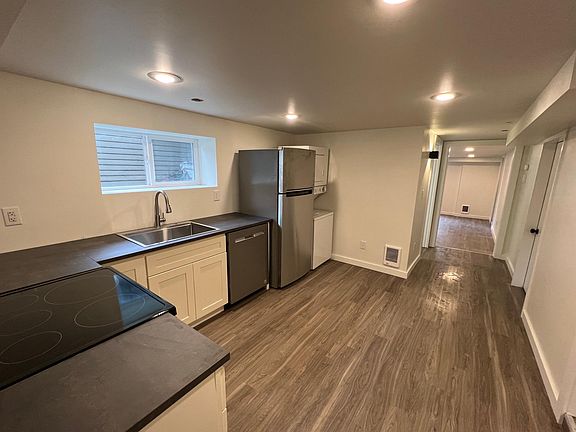 Modern, updated kitchen. View is from entrance, looking towards the living room.