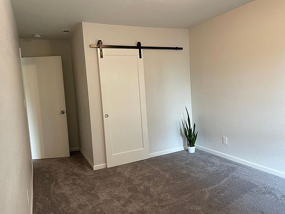 BR2 with attached 3/4 bath and closed barn door.