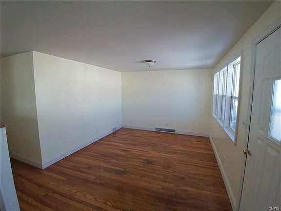Living Room with refinished hardwoods and new LED ceiling light