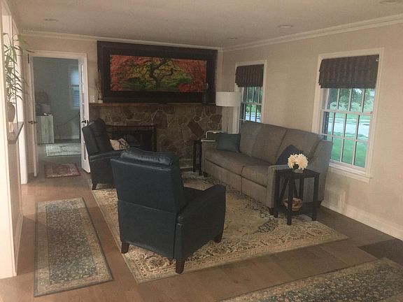 Living room and entry into bonus room office / double sided gas fireplace
