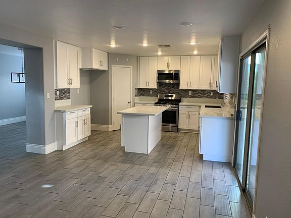 Stainless appliances (fridge included), quartz counters, slow close drawers, single stainless large sink