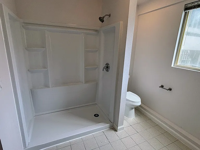 Bathroom with standing shower (new sliding glass door will be installed soon).