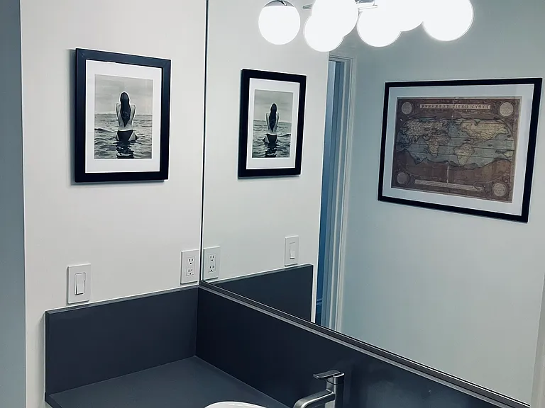 Vanity Area w/large mirror and lighting.