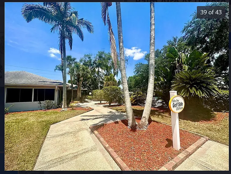 walkway to clubhouse and large pool.