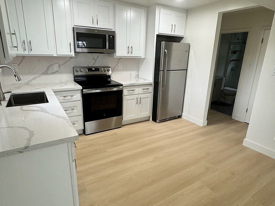 Remodeled kitchen with new stove, refrigerator, dishwasher and microwave.