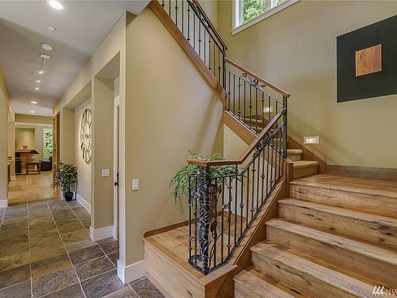 Stunning custom staircase with custom iron and wood hand rail. Staircase landing is perfect for you favorite statue or live potted tree. 
