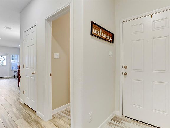 First floor has living area, powder bath, and utility room.