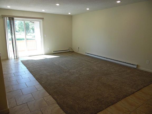 living room w/ sliding glass door to deck w/ golf course view
