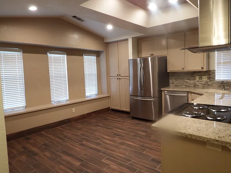 Spacious kitchen/dining room with recessed lighting, extra pantry and window seat.