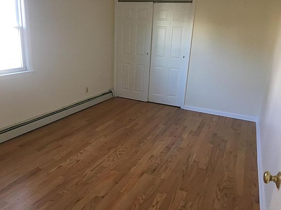 Bedroom with ceiling fan, new hardwood and paint.