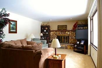Very large, yet cozy living room.  To the right is a picture window overlooking the large back deck and beautiful back yard.  It also features a large fireplace and mantle for the relaxing nights in.  