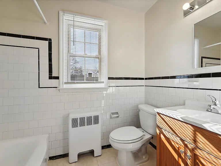 Experience modern luxury in this bright and inviting bathroom, enhanced by natural sunlight.
