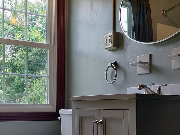 Bathroom with tub/shower, new vanity and mirror.