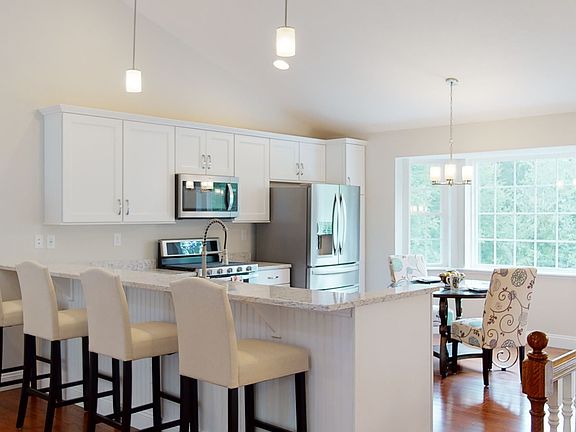 Model home kitchen with double oven and farm house sink