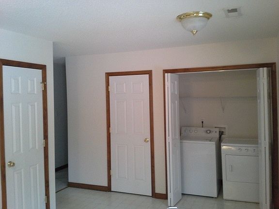 Washer and dryer located in kitchen with sliding doors. Pant