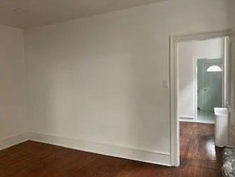 View from Formal dining room into 2nd dining room, kitchen and back exit door
