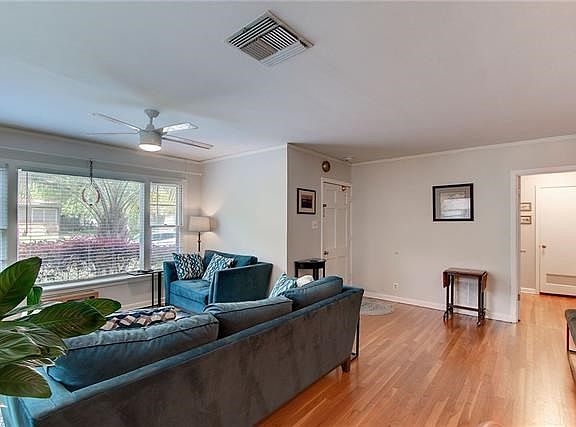 ANOTHER VIEW OF LIVING ROOM WITH ITS HARDWOOD FLOORING.